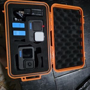 GoPro Camera with Accessories in Orange Case